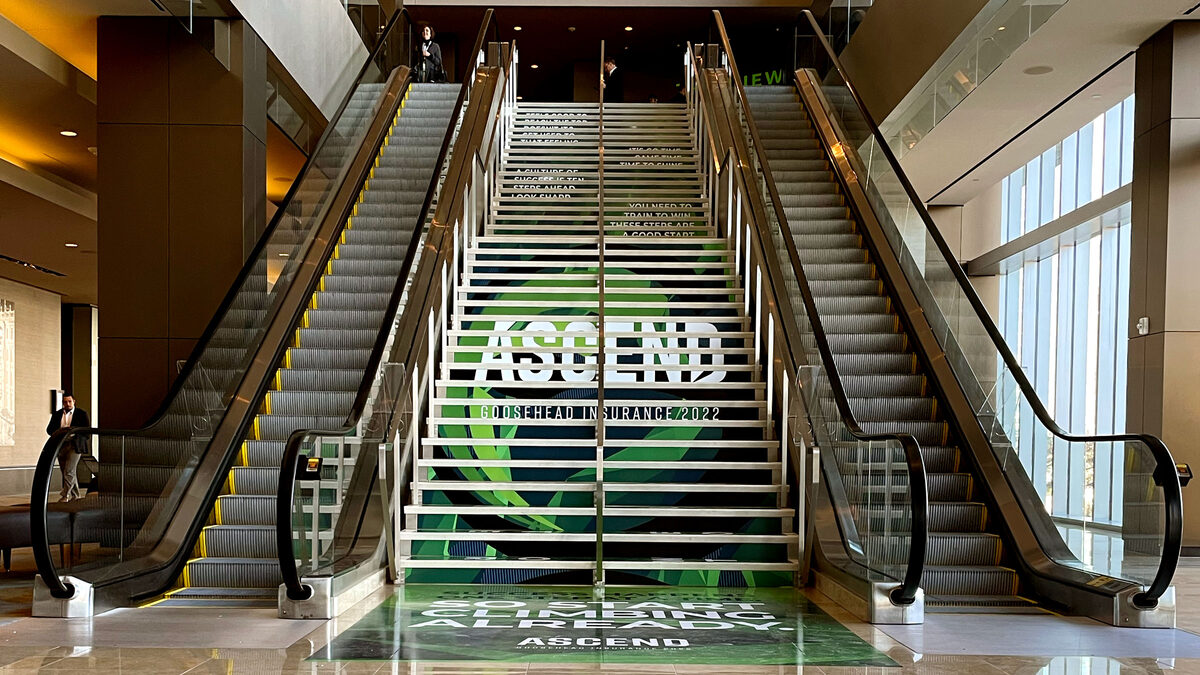 Goosehead Ascend 2022 — multi-story staircase wrap with aviation-themed conference branding