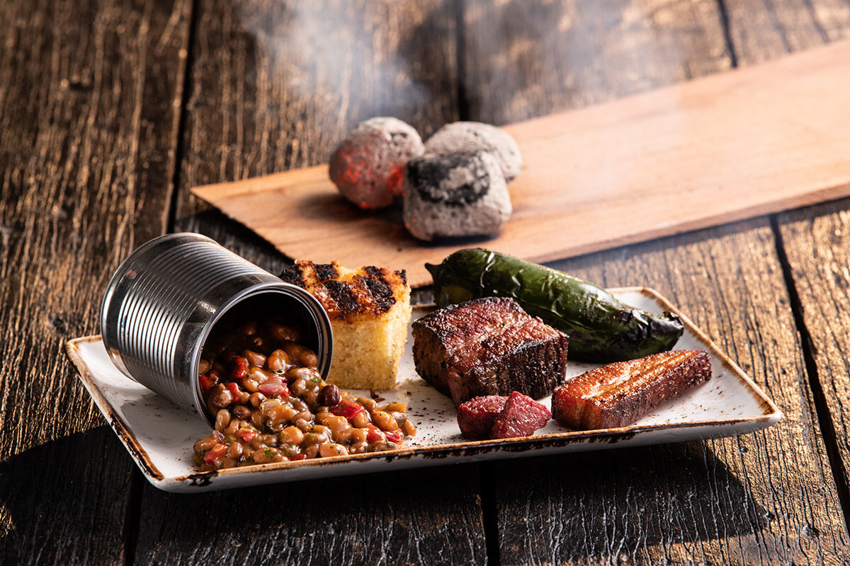 Omni Season of Smoke — smoked short rib plate with cornbread, jalapeño, and cast-iron beans