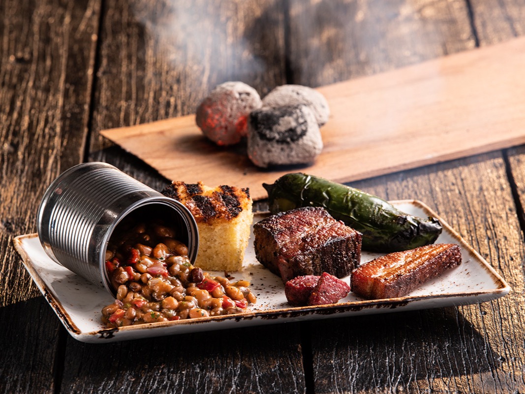 Omni Season of Smoke — smoked brisket plate with cornbread and embers