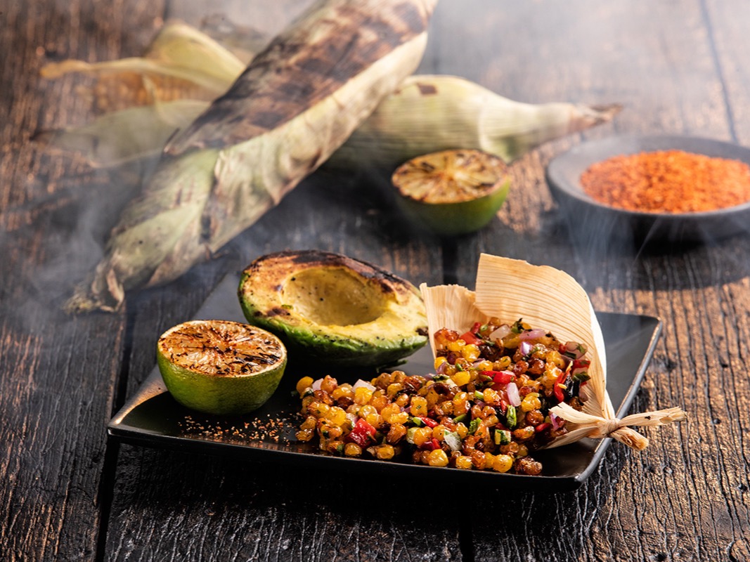 Omni Season of Smoke — grilled corn relish with charred lime and avocado