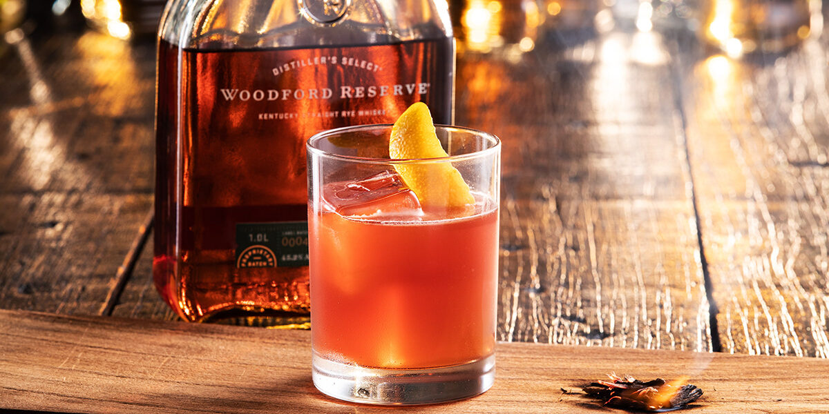 Omni Season of Smoke — The Riff smoked Woodford Reserve cocktail on a charred plank